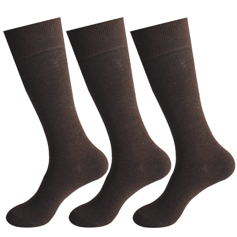 Three pairs of dark brown dress socks with ribbed cuffs displayed against white background