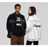 A man and woman are standing side by side. He wears black SANHOMME jacket with '15 06' shirt, she wears white outline denim jacket