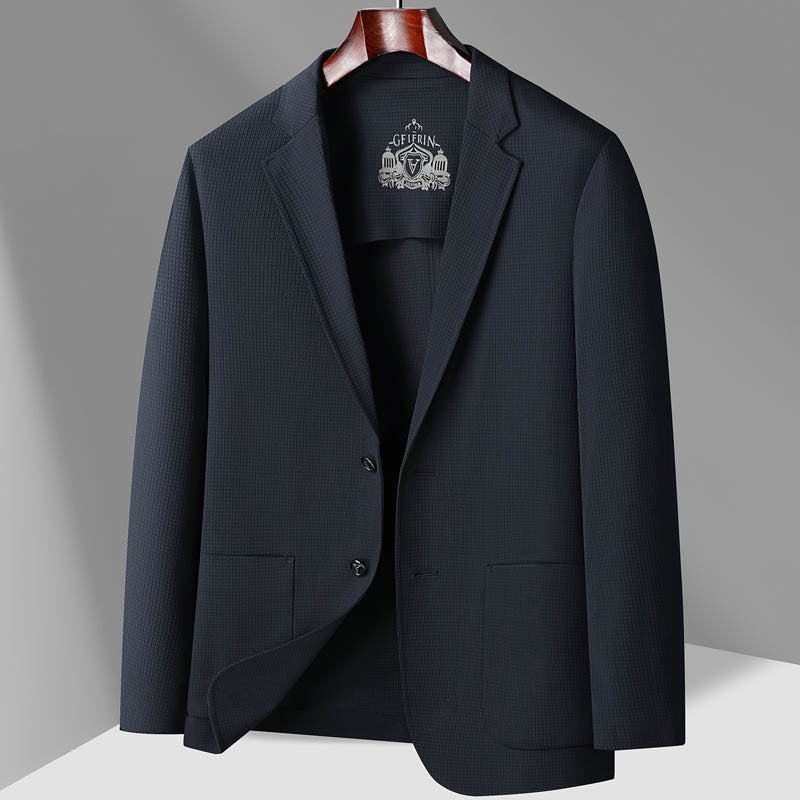 Dark navy GFJFRIN blazer featuring textured fabric pattern, shown on wooden hanger with one flap open against neutral background