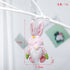 Pink plush bunny gnome with flower detail, hanging from a white branch. Dimensions: 17cm height, 7.5cm width, 6cm depth, weight 17g.