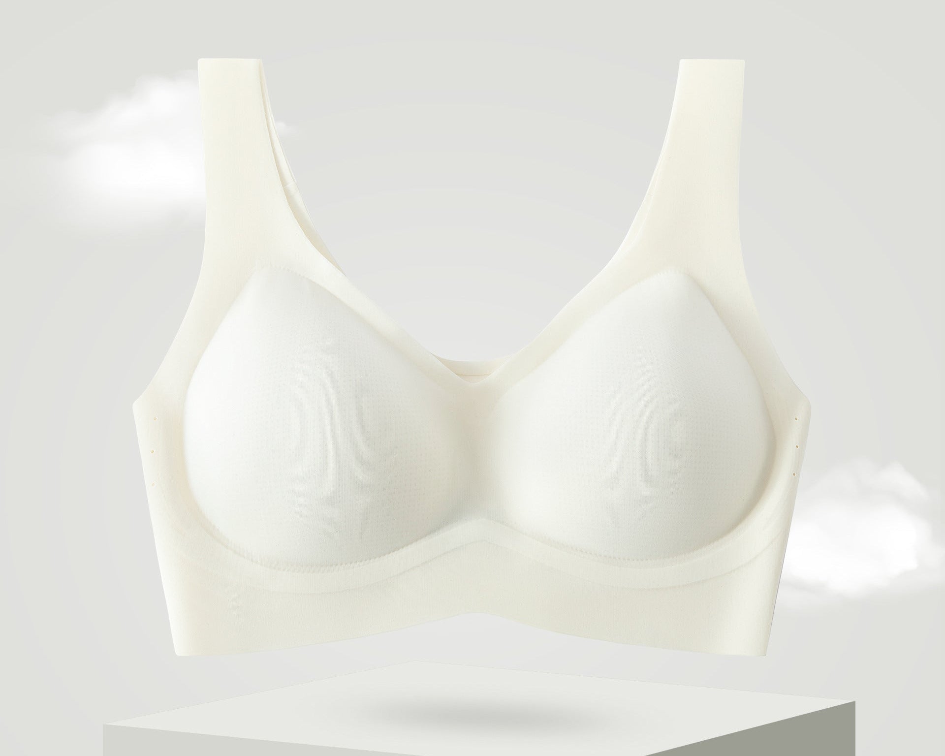 White seamless bra with cooling fabric displayed on a pedestal.