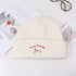 Pure white knit beanie with red text and white puppy embroidered design