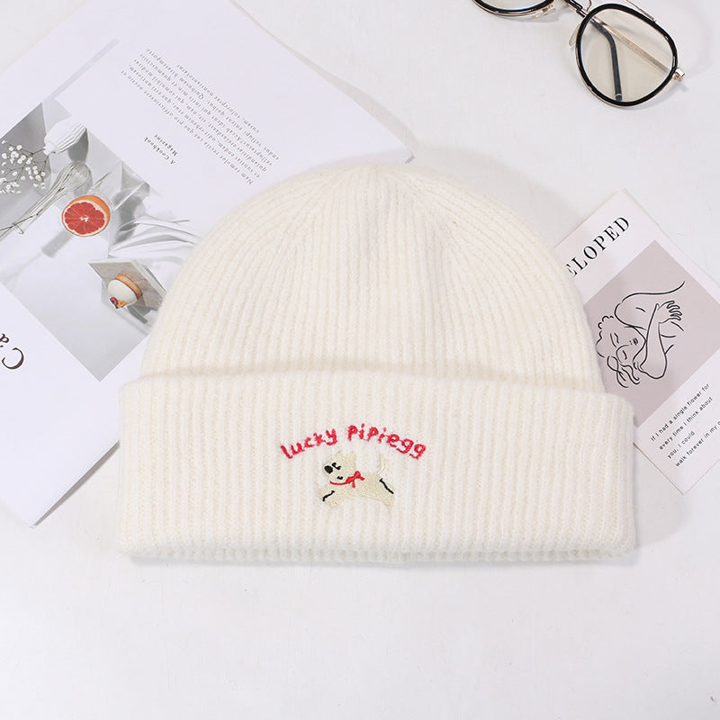 Pure white knit beanie with red text and white puppy embroidered design
