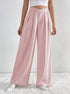 Pink wide-leg trousers with high-rise V-cut waistband and pleats.