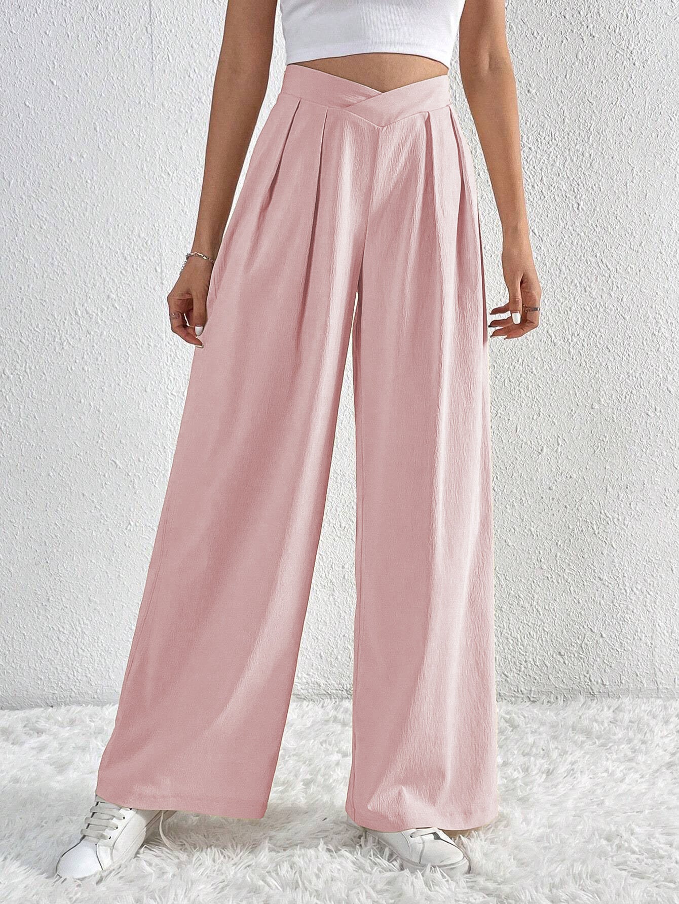 Pink wide-leg trousers with high-rise V-cut waistband and pleats.
