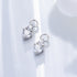 Silver diamond drop charms with double crystal stones in prong settings, photographed on white background in natural light