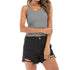 Grey ribbed camisole with lace trim and high-waisted distressed black shorts