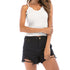 White ribbed camisole top with lace detail and ripped black denim shorts