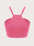 Pink ribbed crop top shown from back view with racerback design and elastic trim displayed against clean white background