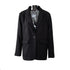 Black oversized blazer on a transparent mannequin, showcasing a structured silhouette with notched lapels and flap pockets