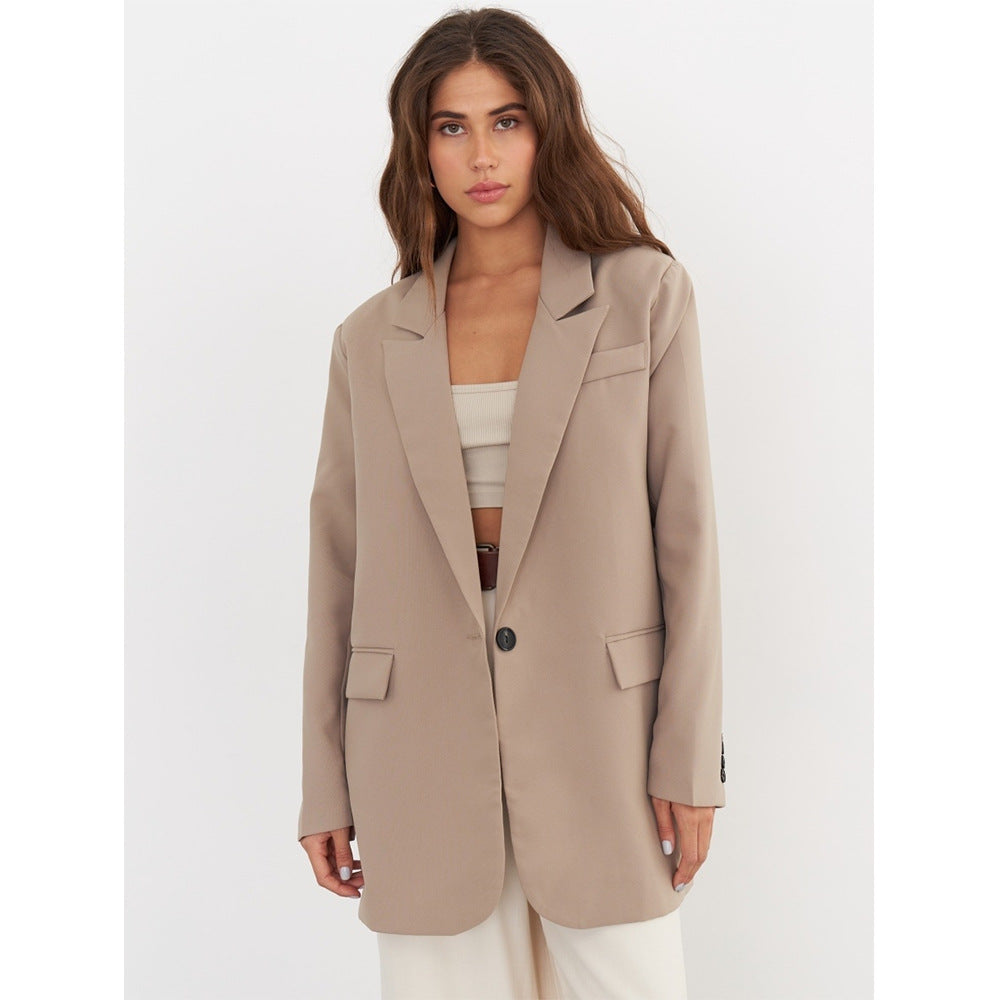 Neutral beige blazer styled over a cream bandeau top and white high-waisted shorts with a brown leather belt, creating a sophisticated ensemble