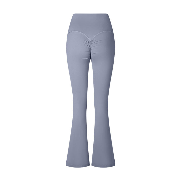 A flat product photo of light gray flared yoga pants with a high waistband and ruched center seam detail, shown against a white background