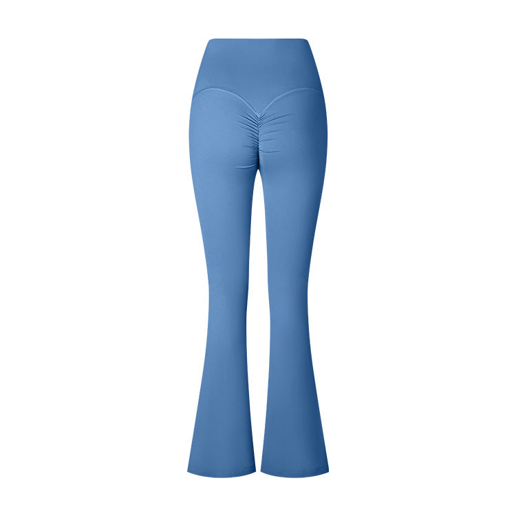 A product photo showing light blue high-waisted yoga pants with flared legs and ruched center detail, photographed flat against a white background