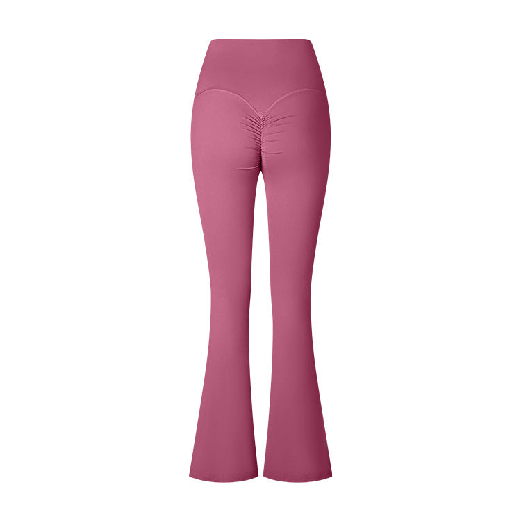 A product photo of dusty rose colored flared yoga pants featuring a high waistband and ruched center detail, shown against a white background