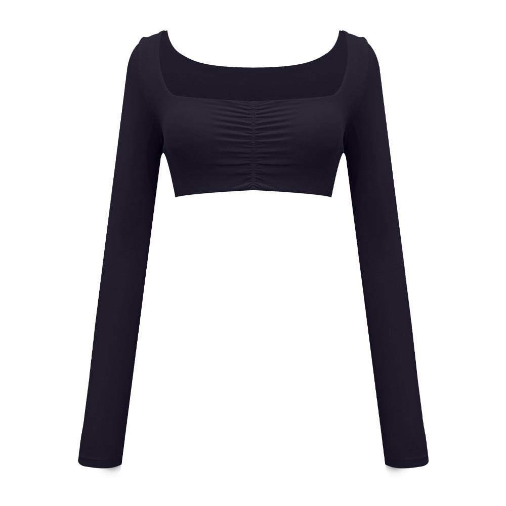 Black athletic crop top with long sleeves and ruched front detail, displayed on white background