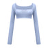 Light blue long-sleeve crop top featuring square neckline and gathered center detail on white backdrop
