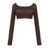 Dark brown long-sleeve athletic crop top with ruched front panel and square neckline on white background
