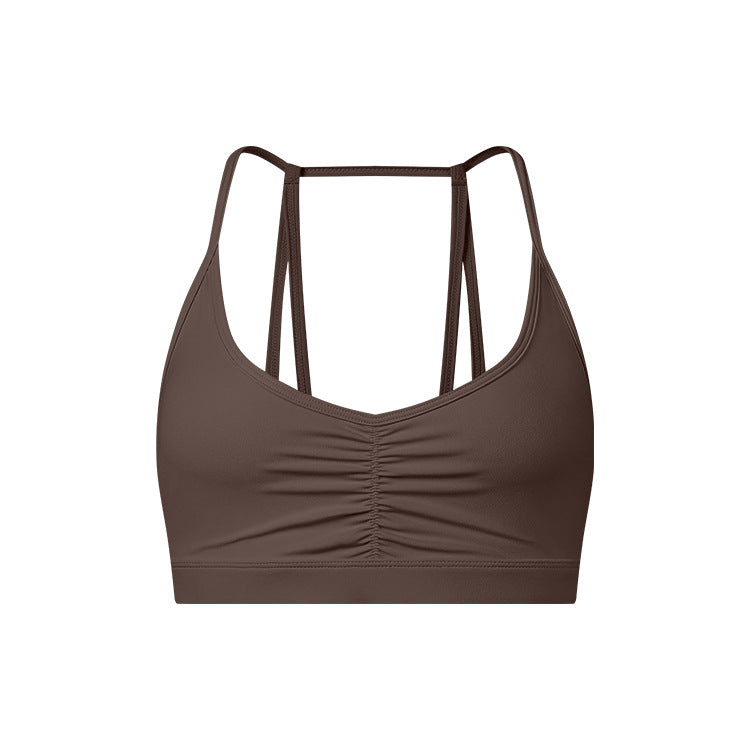 A dark brown strappy sports bra with ruched center detail and thin double-strap design shown against white background