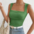 Sage green ribbed tank with square neckline, worn with light jeans and beige handbag