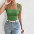 Woman wearing sage green square neck tank top with ruched bust detail and white belt with gold buckle