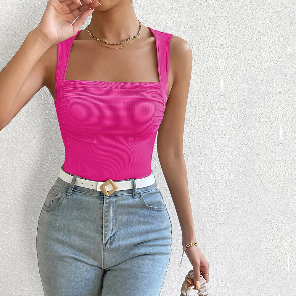 Hot pink ribbed tank top with square neckline, styled with light jeans and white belt with gold buckle