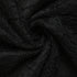  A detailed view of the black lace fabric, highlighting its semi-sheer and soft woven texture.