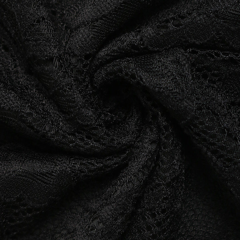  A detailed view of the black lace fabric, highlighting its semi-sheer and soft woven texture.