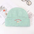 Mint green winter beanie with Lucky Pipiegg branding and puppy motif