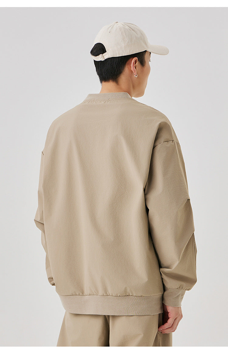 Back view of the beige oversized sweatshirt, featuring a relaxed drop-shoulder fit