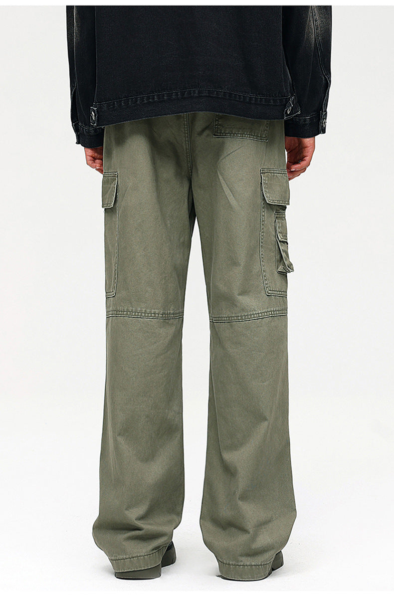 Back view of black denim jacket with olive green wide-leg cargo pants featuring multiple utility pockets against white backdrop