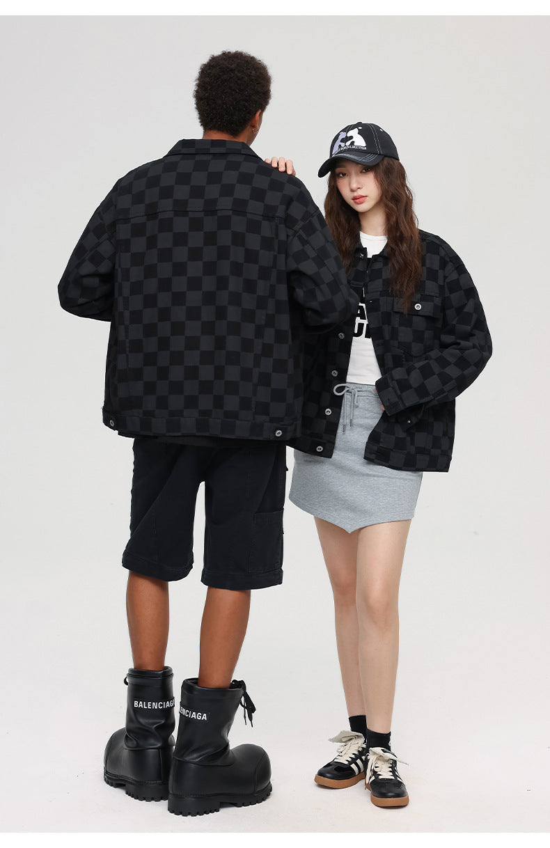 Back view portrait of couple in matching black checkered jackets, showing streetwear styling contrast