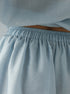 Light blue skirt with an elastic waistband on a plain background