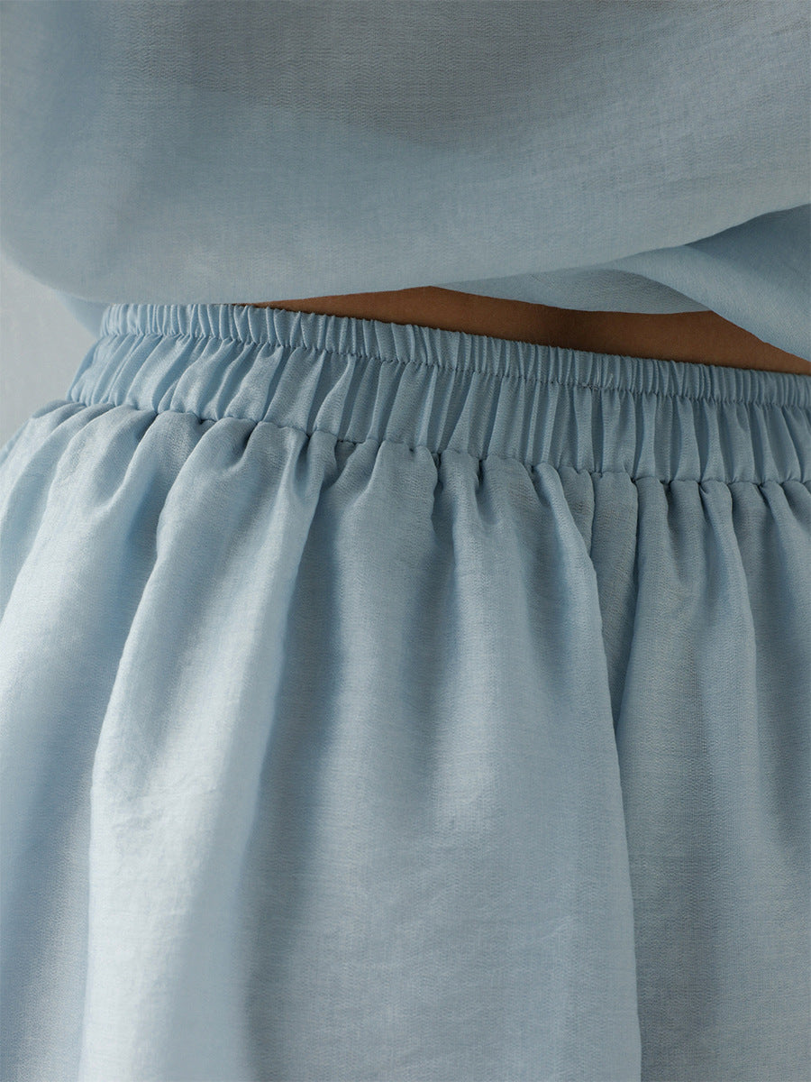 Light blue skirt with an elastic waistband on a plain background