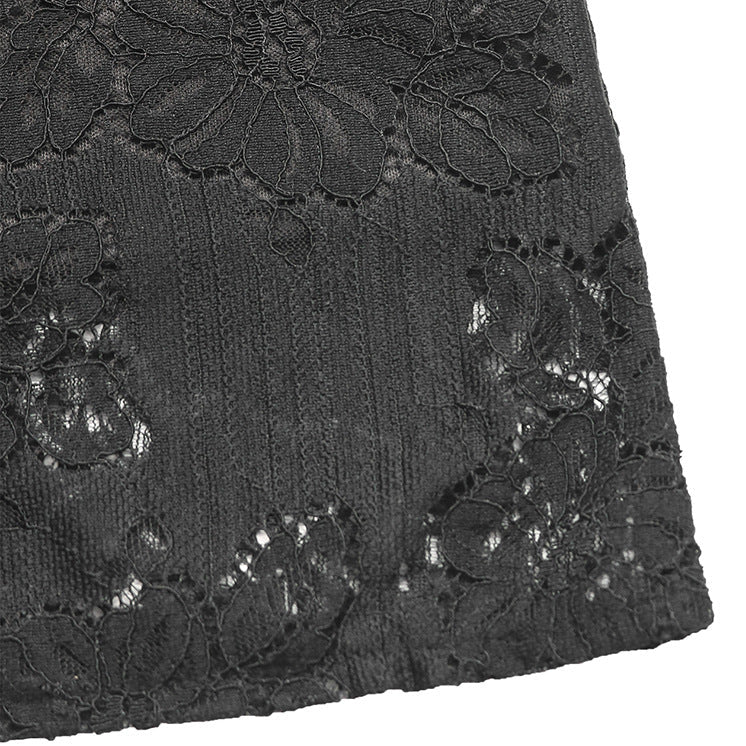 Fabric close-up of black lace blouse, showcasing intricate floral patterns and semi-sheer texture.