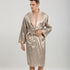 Man in beige diamond pattern silk robe with matching belt. Close-up shows detailed stitching and champagne-colored satin collar against studio lighting