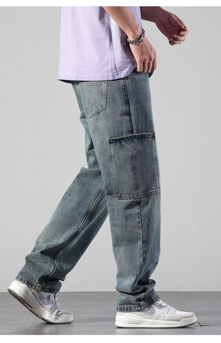 Model walking in relaxed-fit cargo denim jeans with patch pockets, styled with lavender oversized tee and white athletic shoes