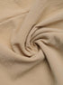 Fabric texture of beige high-waisted shorts, showcasing the soft, crinkled material.
