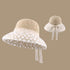 A vanilla woven sun hat with a floral lace-trimmed brim and a ribbon bow at the back, displayed in two angles for a closer look at the design.