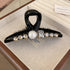 A black acrylic hair claw clip with a teardrop-shaped loop, accented with a pearl centerpiece and sparkling rhinestones.