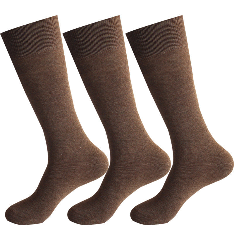 Three pairs of medium brown dress socks with ribbed cuffs displayed against white background