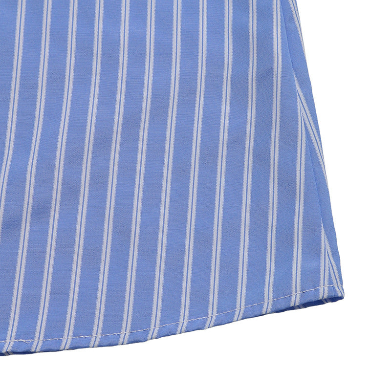 The hem of the dress showing the vertical stripe pattern and neatly stitched edge.