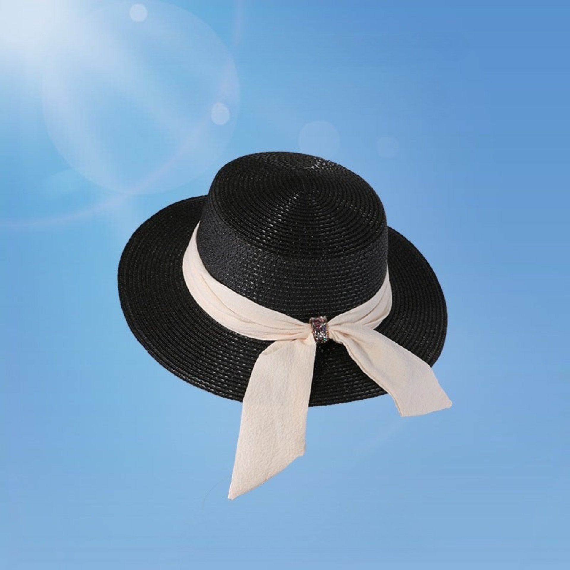 Black women's wide brim straw hat with a cream bow and crystal embellishment. A timeless sun hat offering both style and UV protection.
