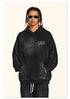 Back view of person with braided hair in black washed hoodie featuring metal-style logo and checklist text