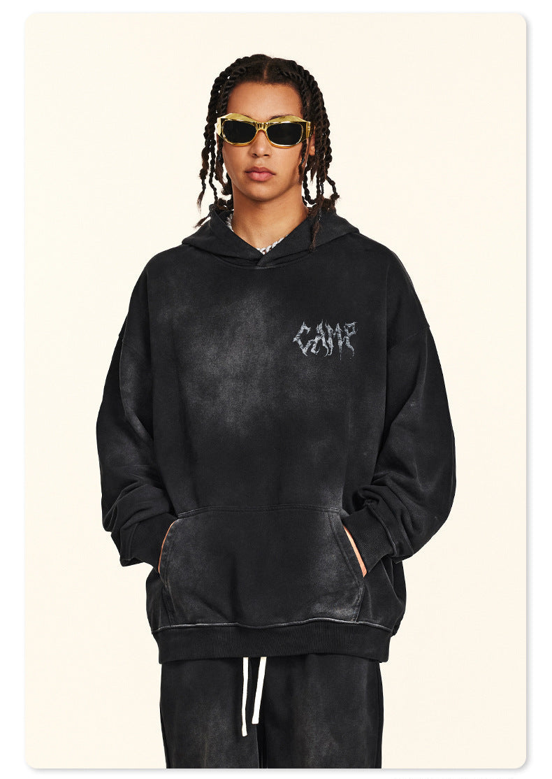 Back view of person with braided hair in black washed hoodie featuring metal-style logo and checklist text