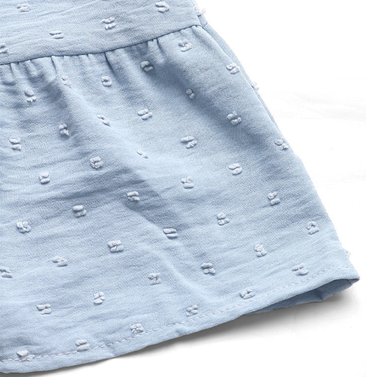 Close-up of the hemline of a baby blue tiered babydoll dress, showcasing the fabric texture.