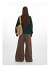 Back view of green sweater and brown wide-leg pants ensemble