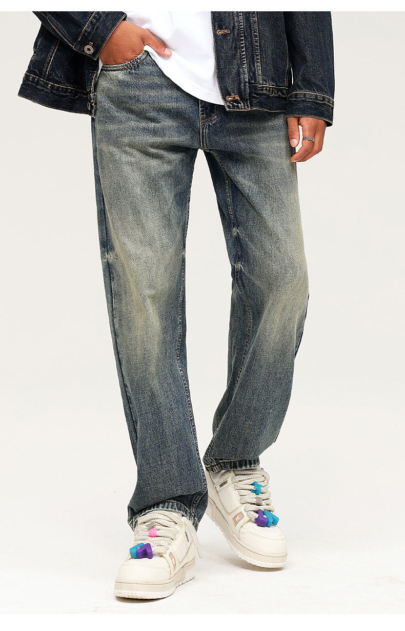 Close-up of relaxed fit vintage wash jeans with classic 5-pocket styling and white platform sneakers