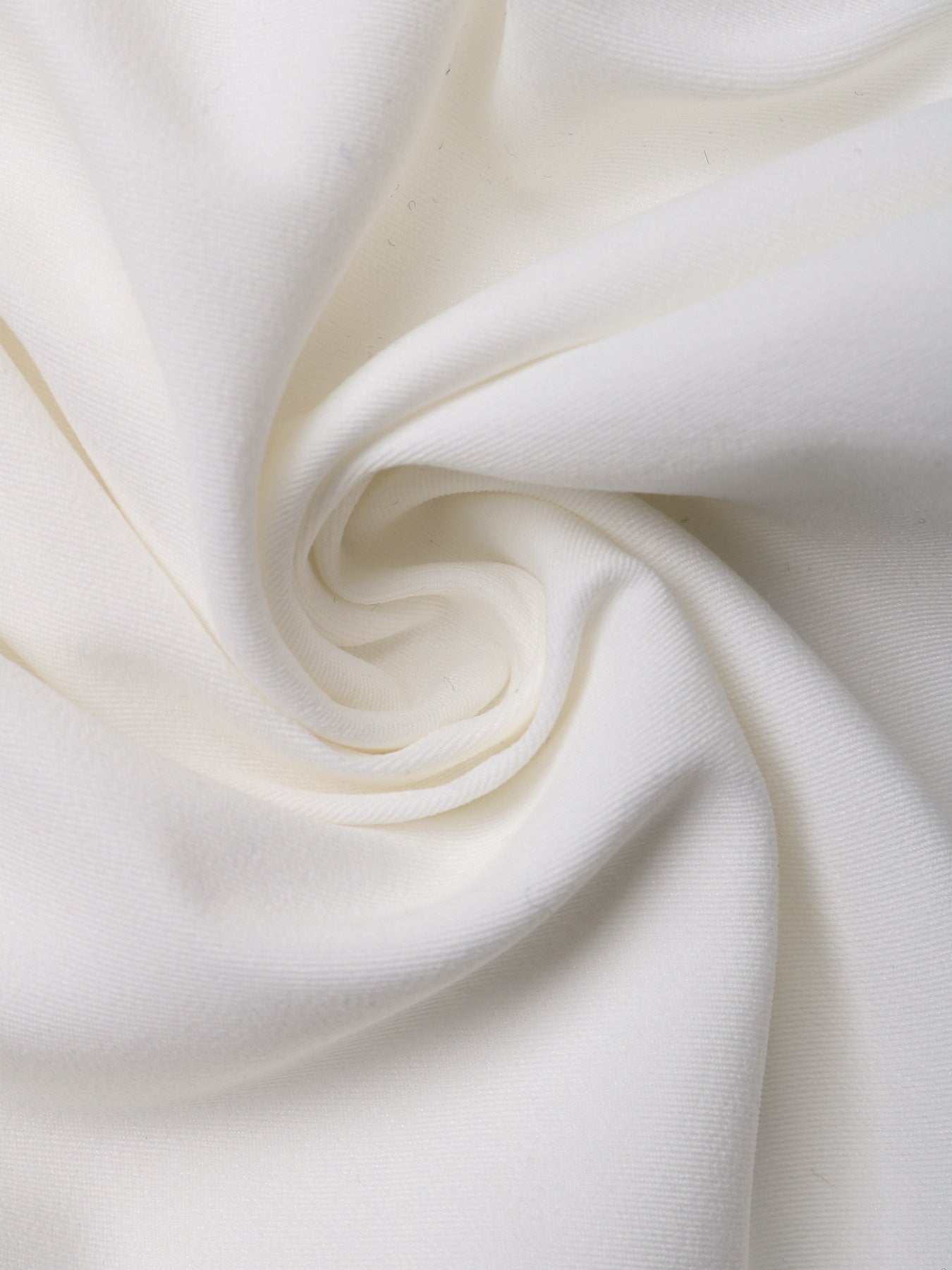 Swirled white fabric showcasing the texture and softness of the material.
