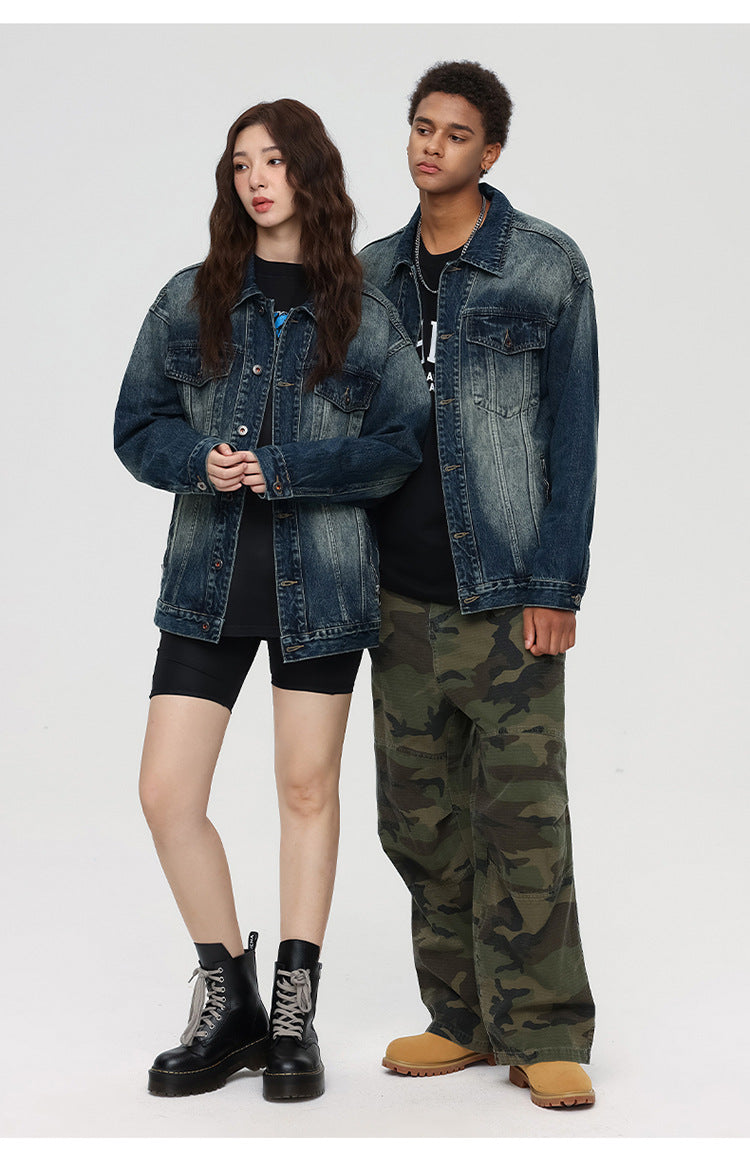 Full-length shot of models in denim jackets, one wearing cycling shorts and combat boots, other in camo pants