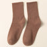A pair of brown ribbed crew socks displayed flat against cream background showing texture and full length